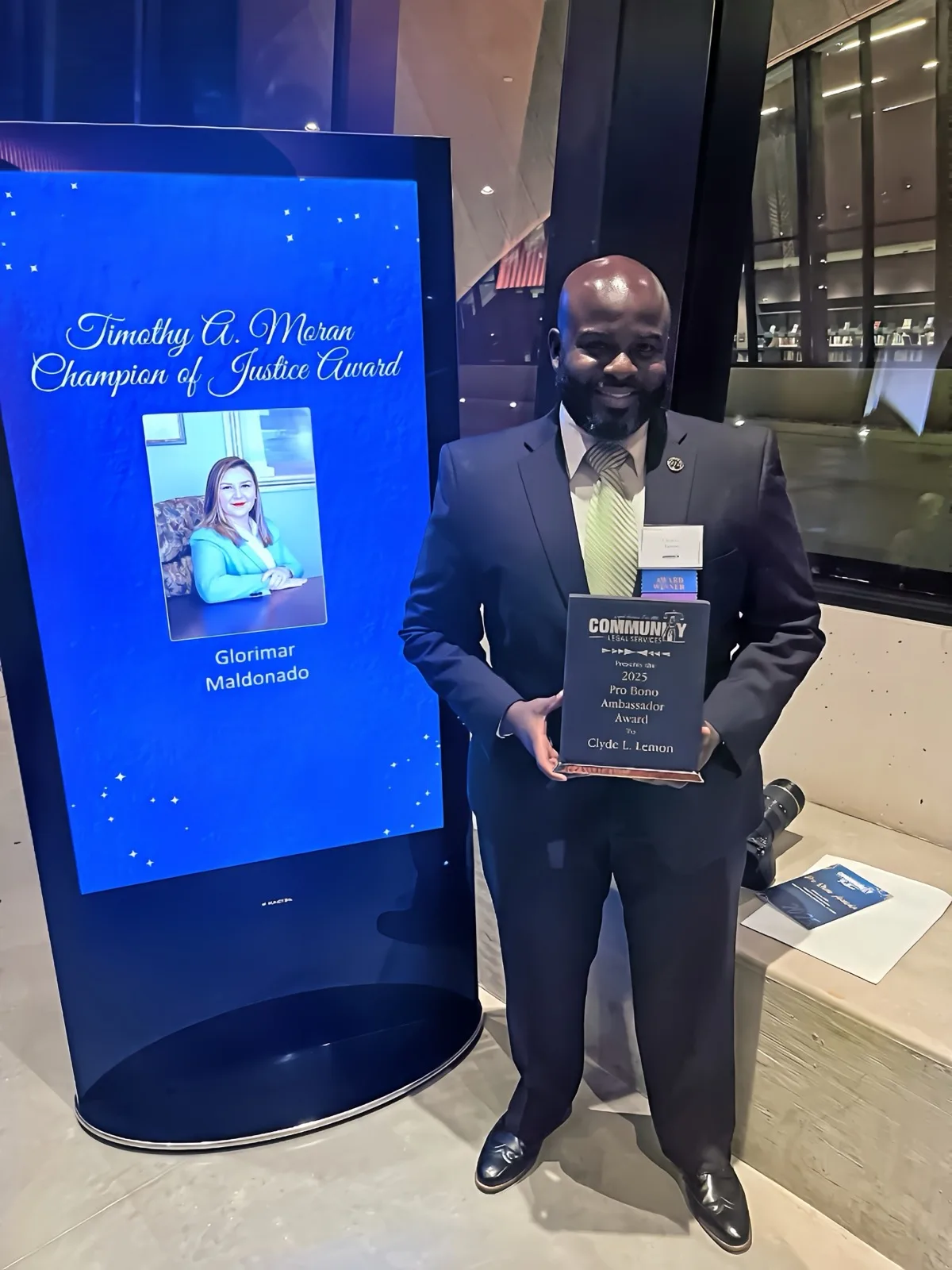 Clyde L. Lemon, Esq. accepting the 2025 Pro Bono Ambassador Award from Community Legal Services of Mid-Florida.